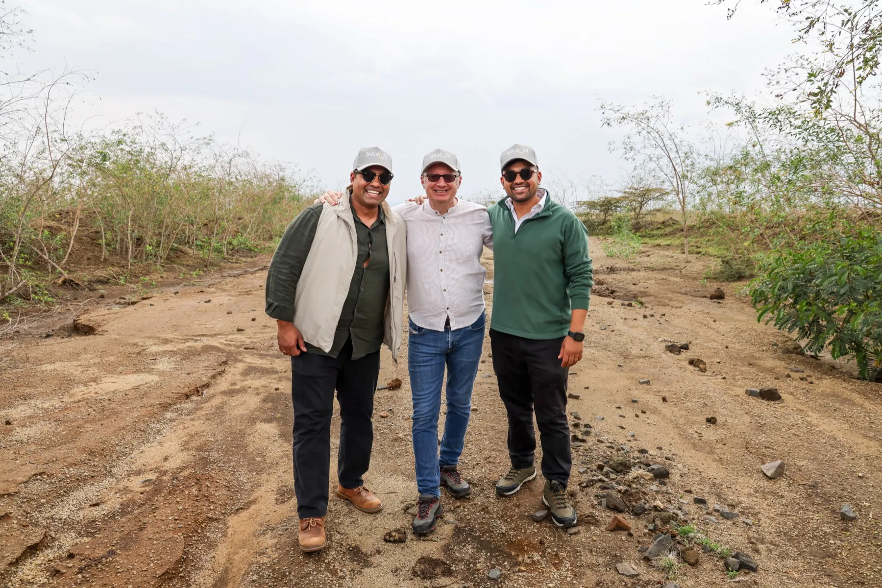 Site walkthrough at Hells Gate — three colleagues on the access road
